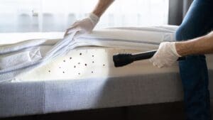 a person inspecting a mattress for bed bugs
